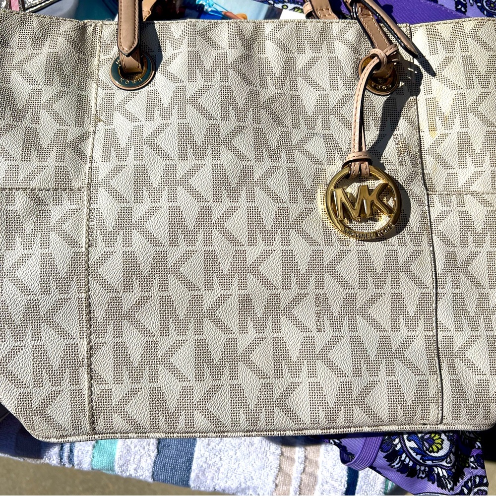 michael kors cream bag, some signs of wear inside of bag.